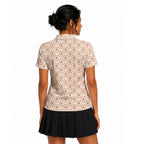 Lone Spur golf shirt for women in Orange on a golfer, back view
